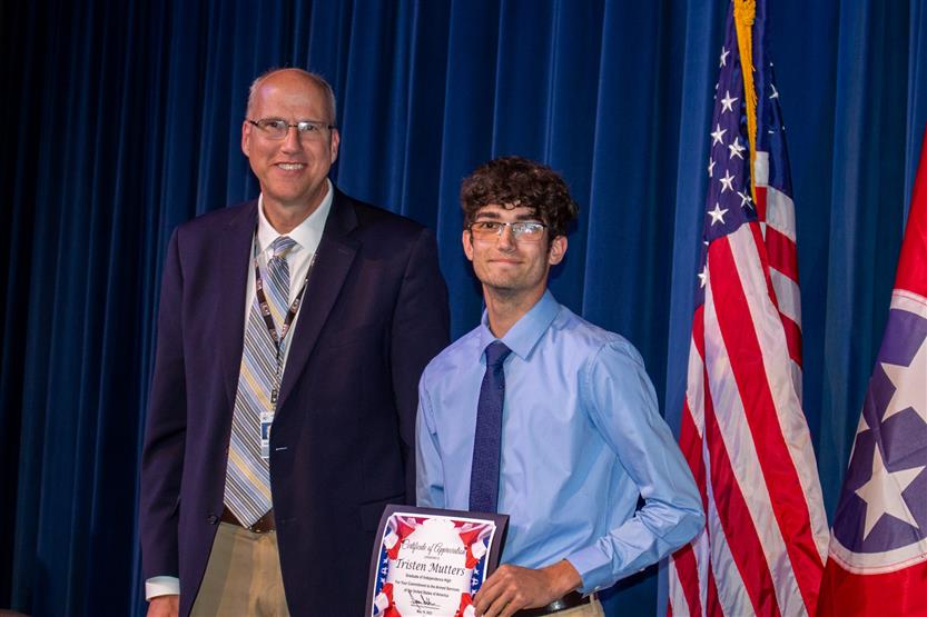 A student is honored for serving in the US Armed Forces after high school